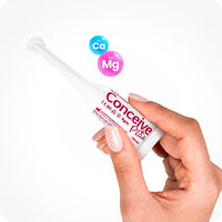 For Conceive Plus Fertility Lubricant Tube + Applicators bundle, the image shows one 4g pre-filled applicator being held between fingers. The sleek white design features pink branding, with calcium and magnesium ion icons displayed above against a white background.